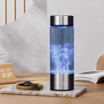 Hydrogen water bottle glowing with bubbles on a wooden table, placed beside a book and clock for home lifestyle context.
